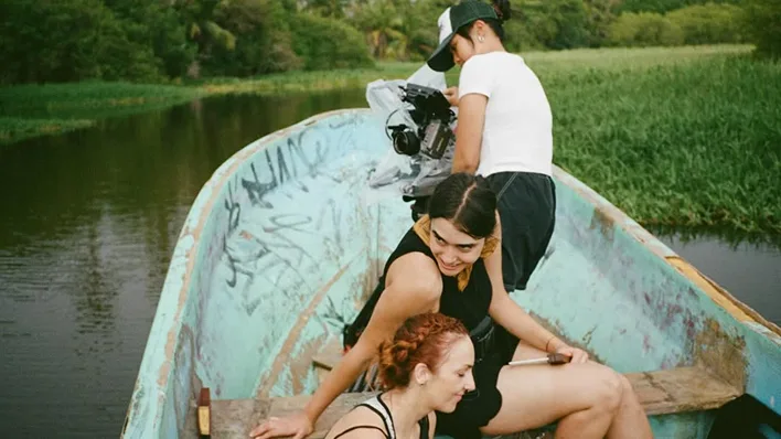 Local production crew filming on a boat in Mexico